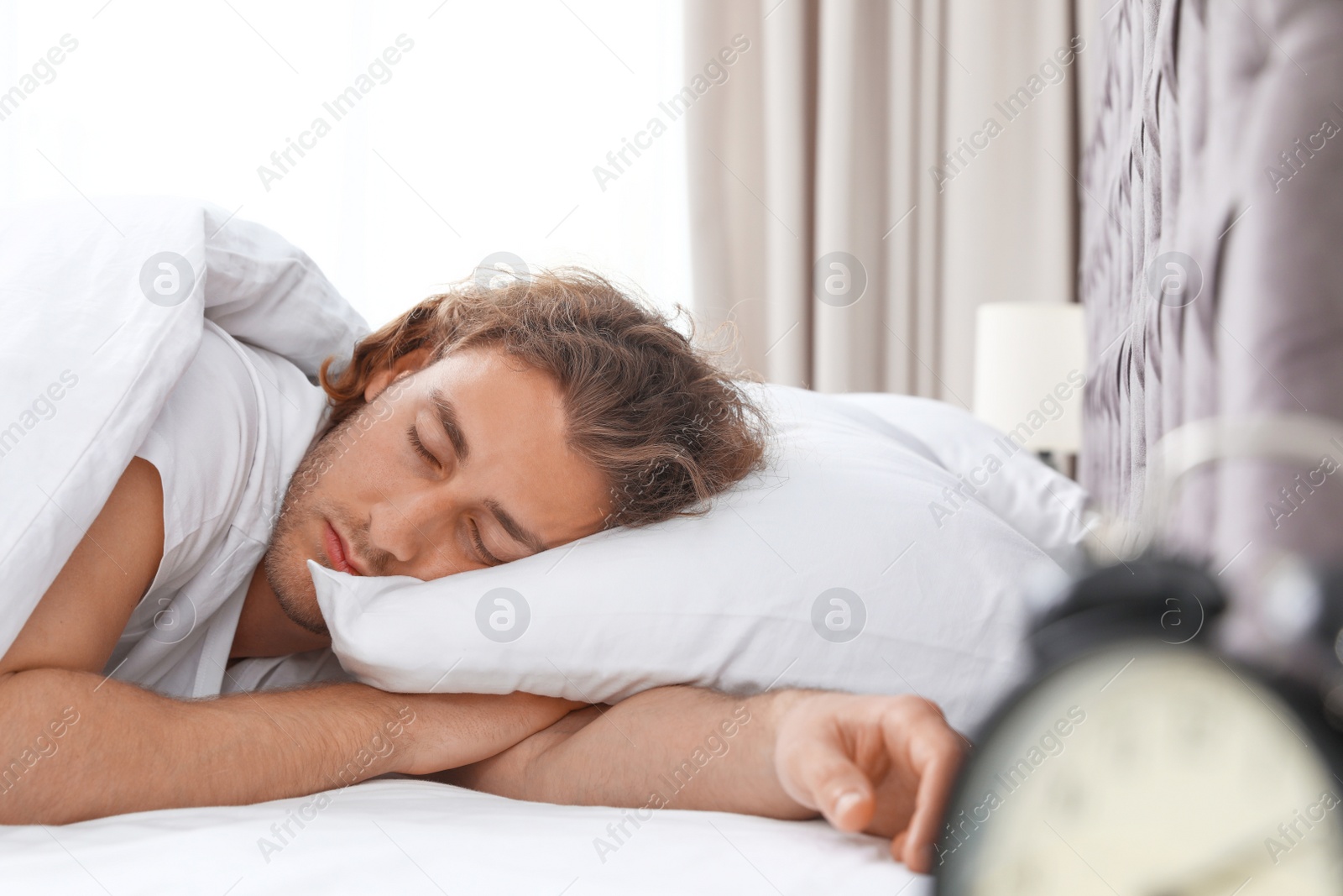 Photo of Handsome young man sleeping on pillow at home. Bedtime