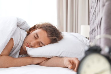 Handsome young man sleeping on pillow at home. Bedtime