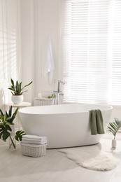 Photo of Stylish bathroom interior with green plants. Home design