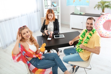 Beautiful young couple visiting travel agency office