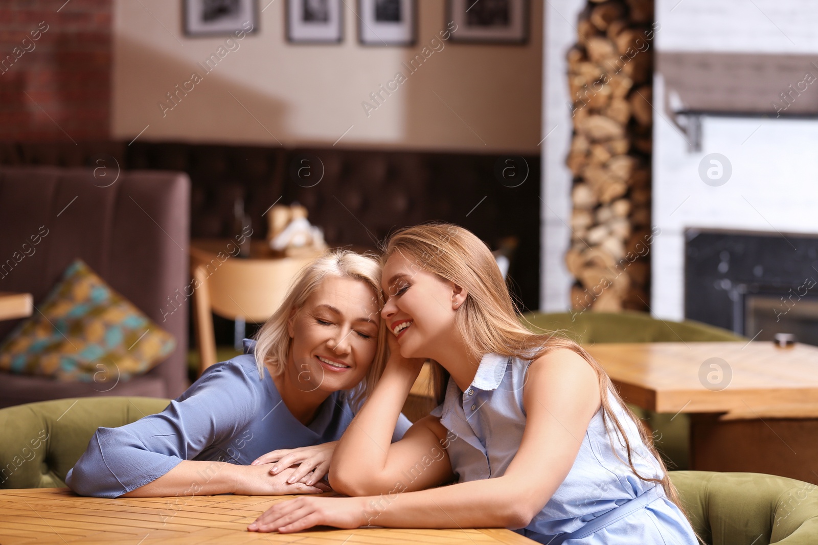 Photo of Mother and her adult daughter spending time together in cafe