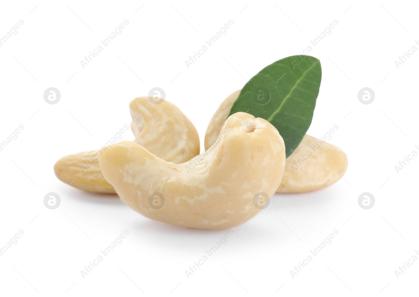 Photo of Tasty organic cashew nuts and green leaf isolated on white, closeup