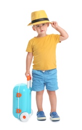 Photo of Cute little boy with hat and blue suitcase on white background
