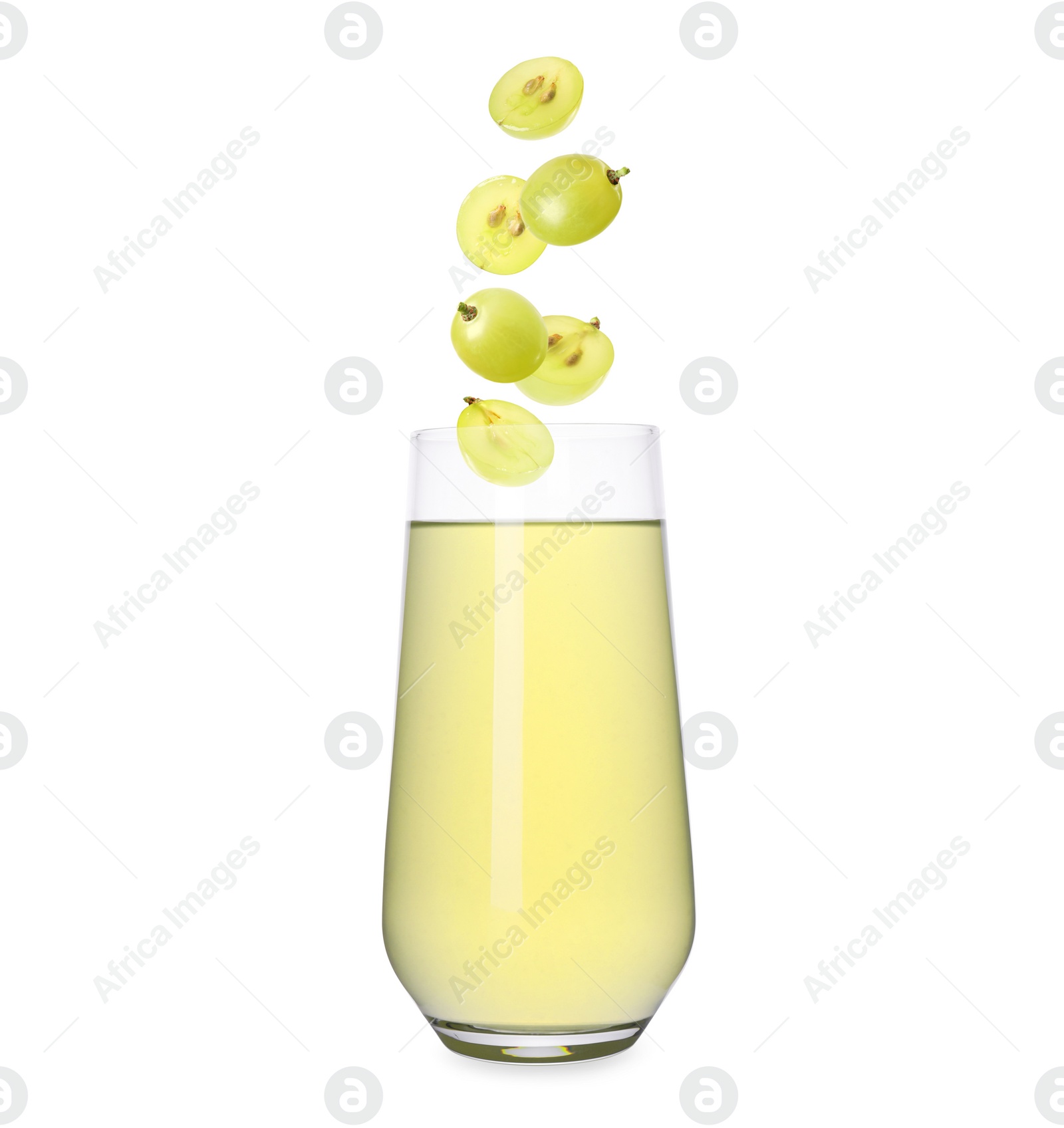 Image of Freshly made grape juice on white background. Cut and whole berries falling into glass