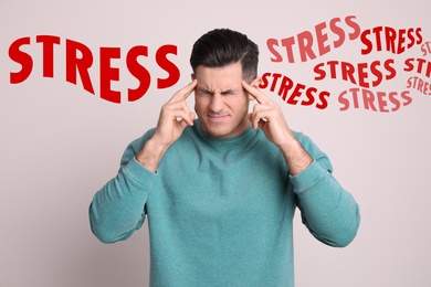 Stressed young man and text on light background