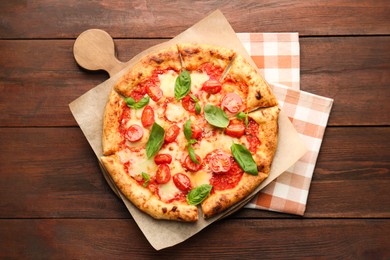 Delicious Margherita pizza on wooden table, top view