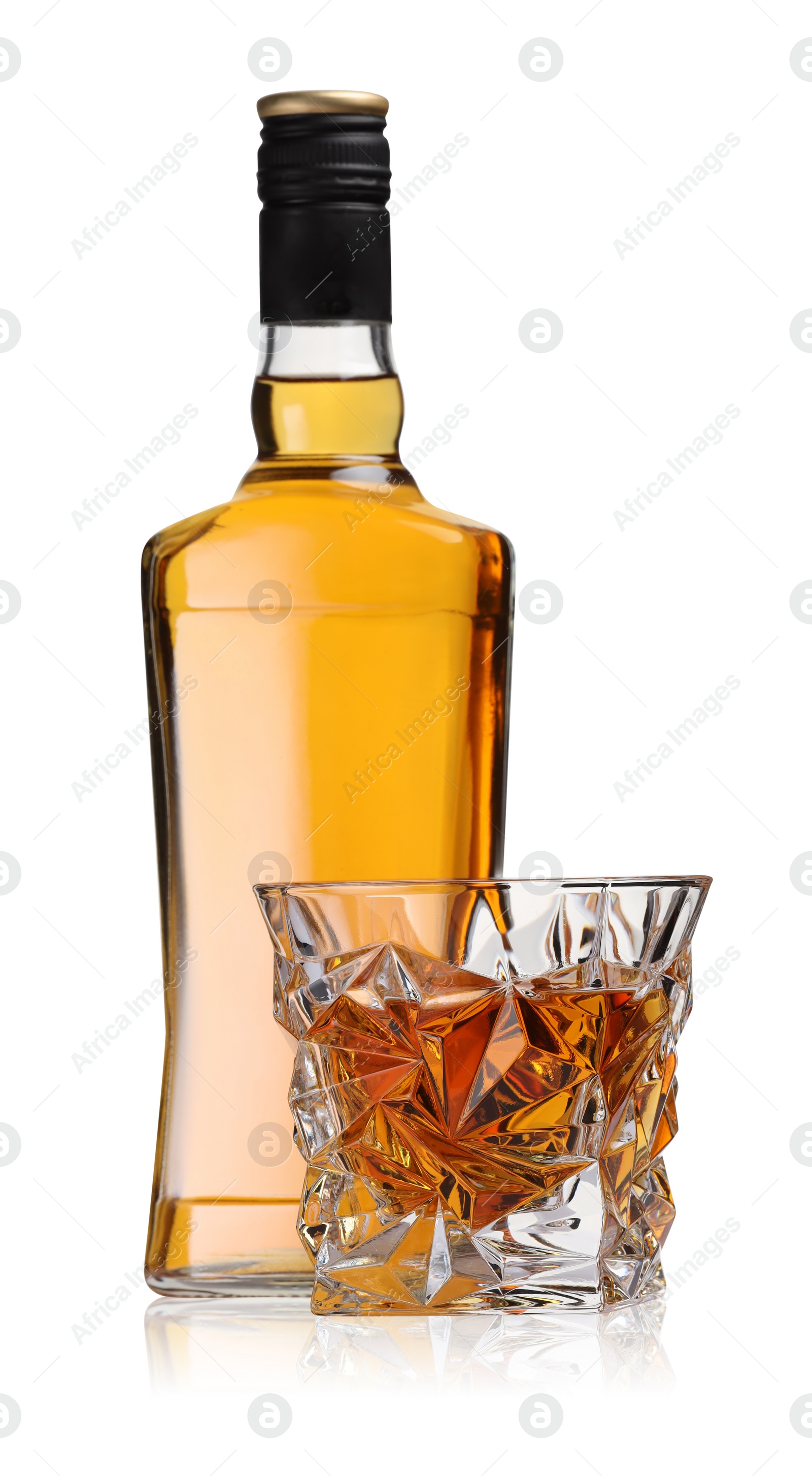 Photo of Glass and bottle of whiskey isolated on white