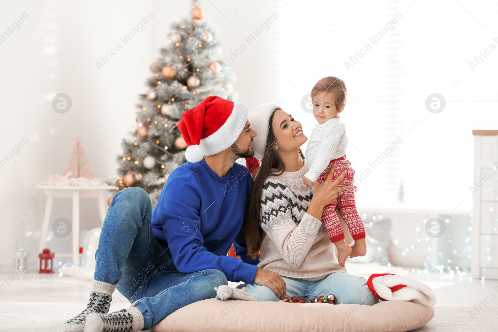 Photo of Happy family with cute baby at home. Christmas celebration