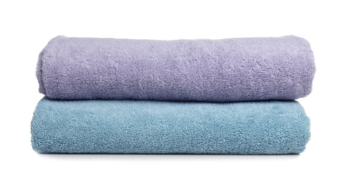 Photo of Folded soft terry towels on white background