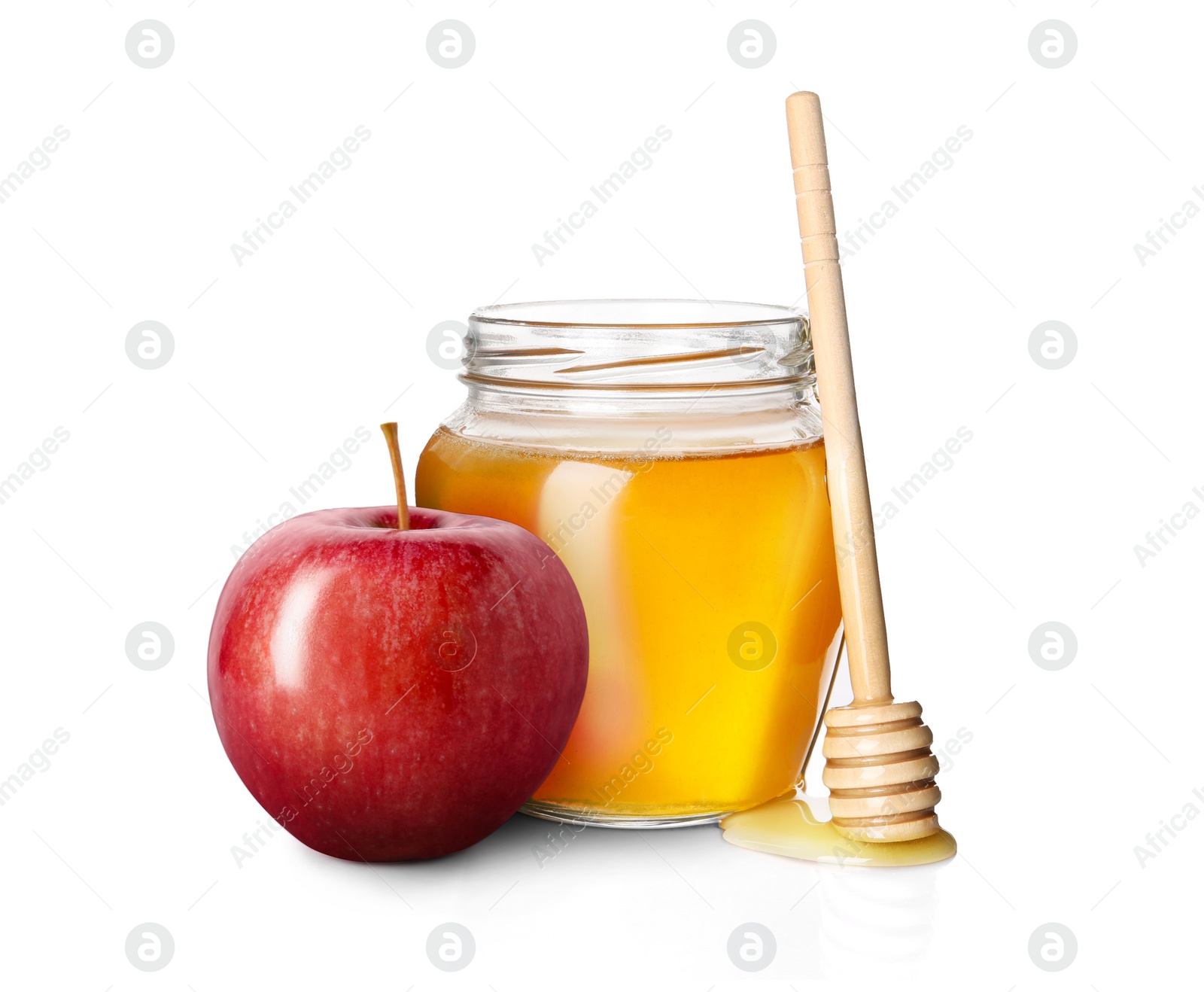 Image of Honey in glass jar, apple and dipper isolated on white