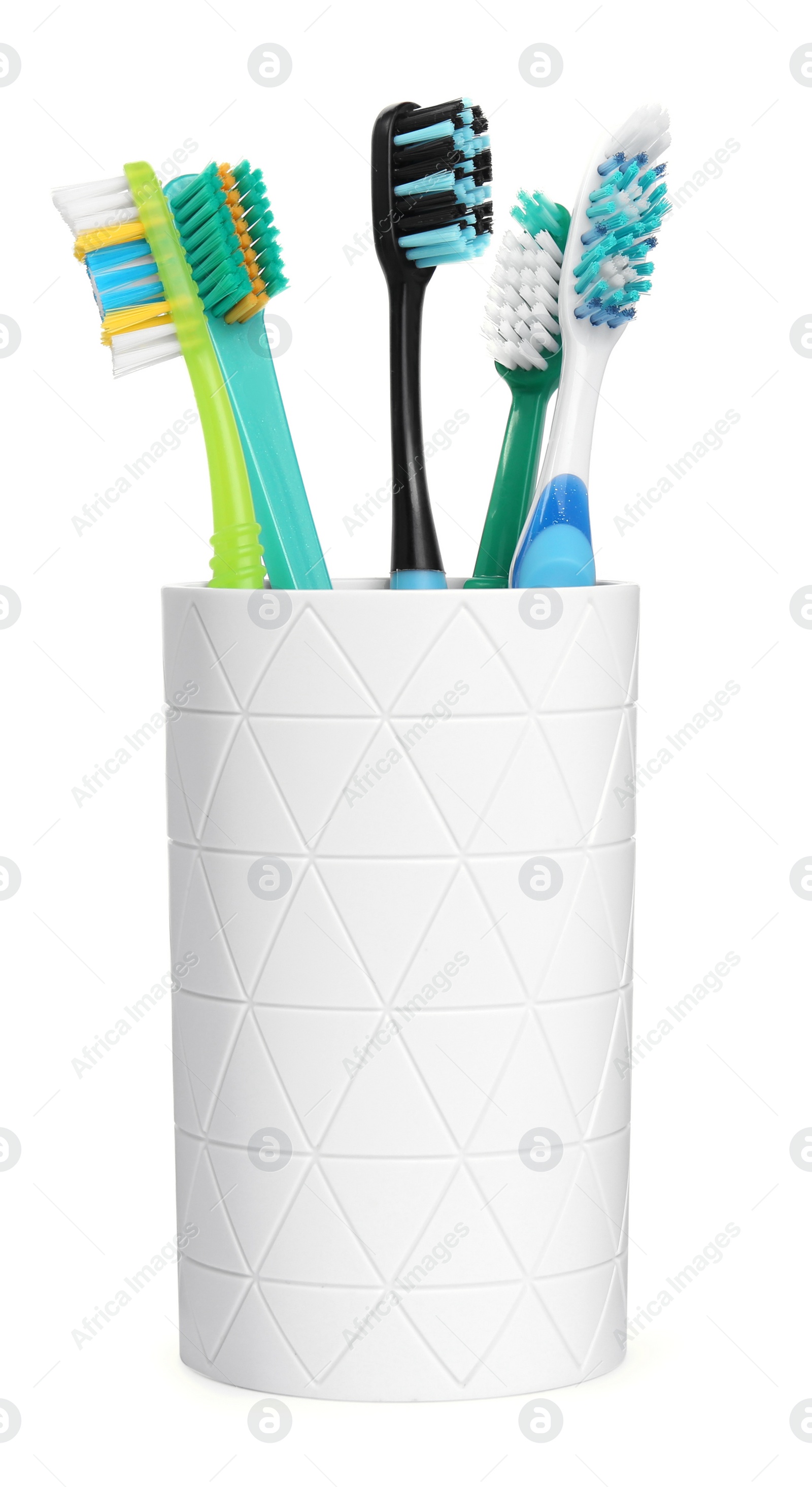 Photo of Different toothbrushes in holder isolated on white