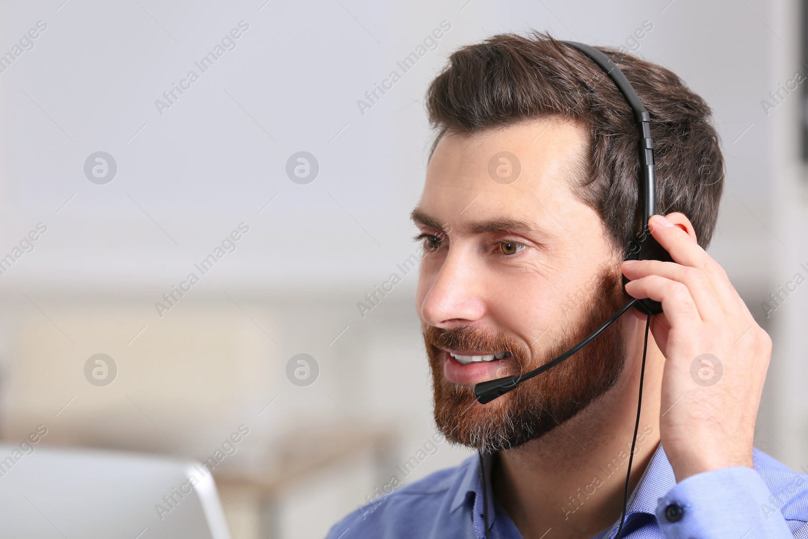 Photo of Hotline operator with headset working in office, space for text