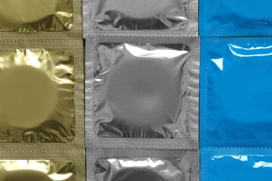 Condom packages as background, top view. Safe sex