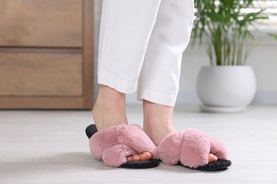 Photo of Woman in soft slippers at home, closeup