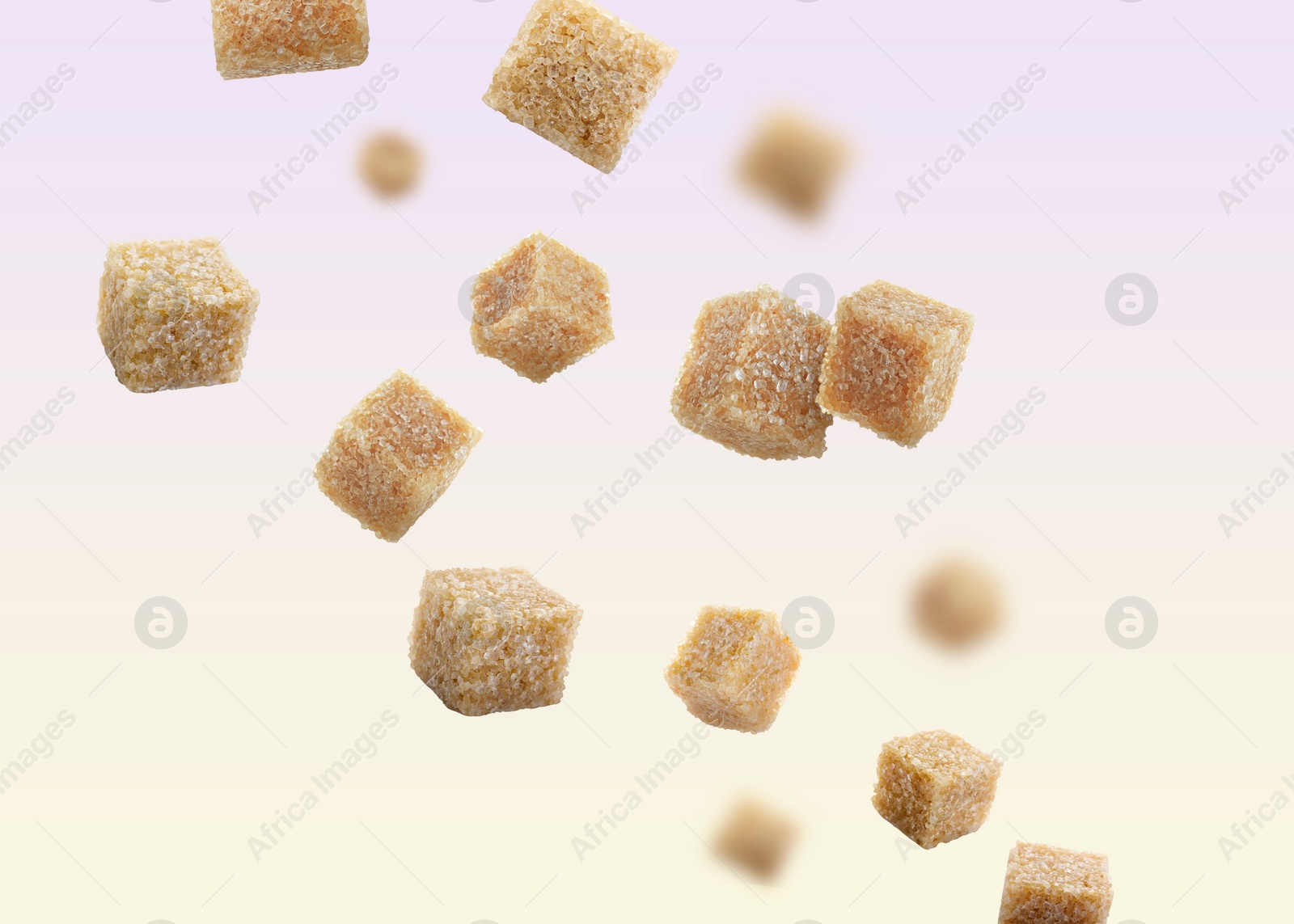 Image of Brown cane sugar cubes falling on color gradient background