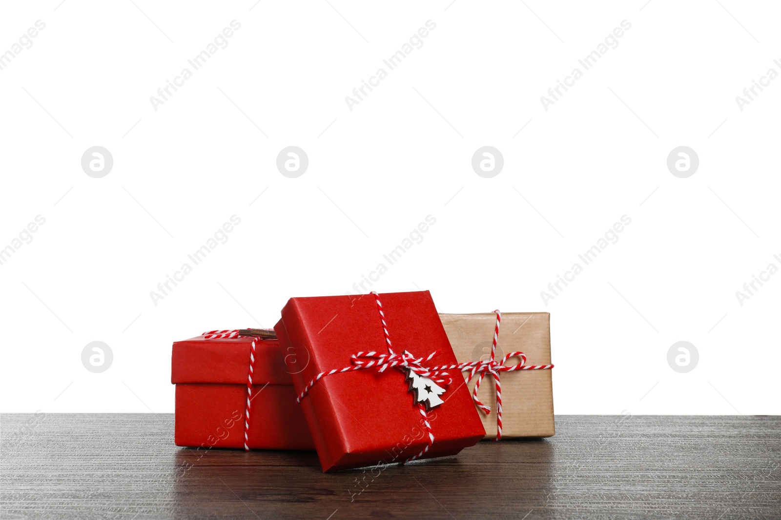 Photo of Different Christmas gifts on wooden table against white background