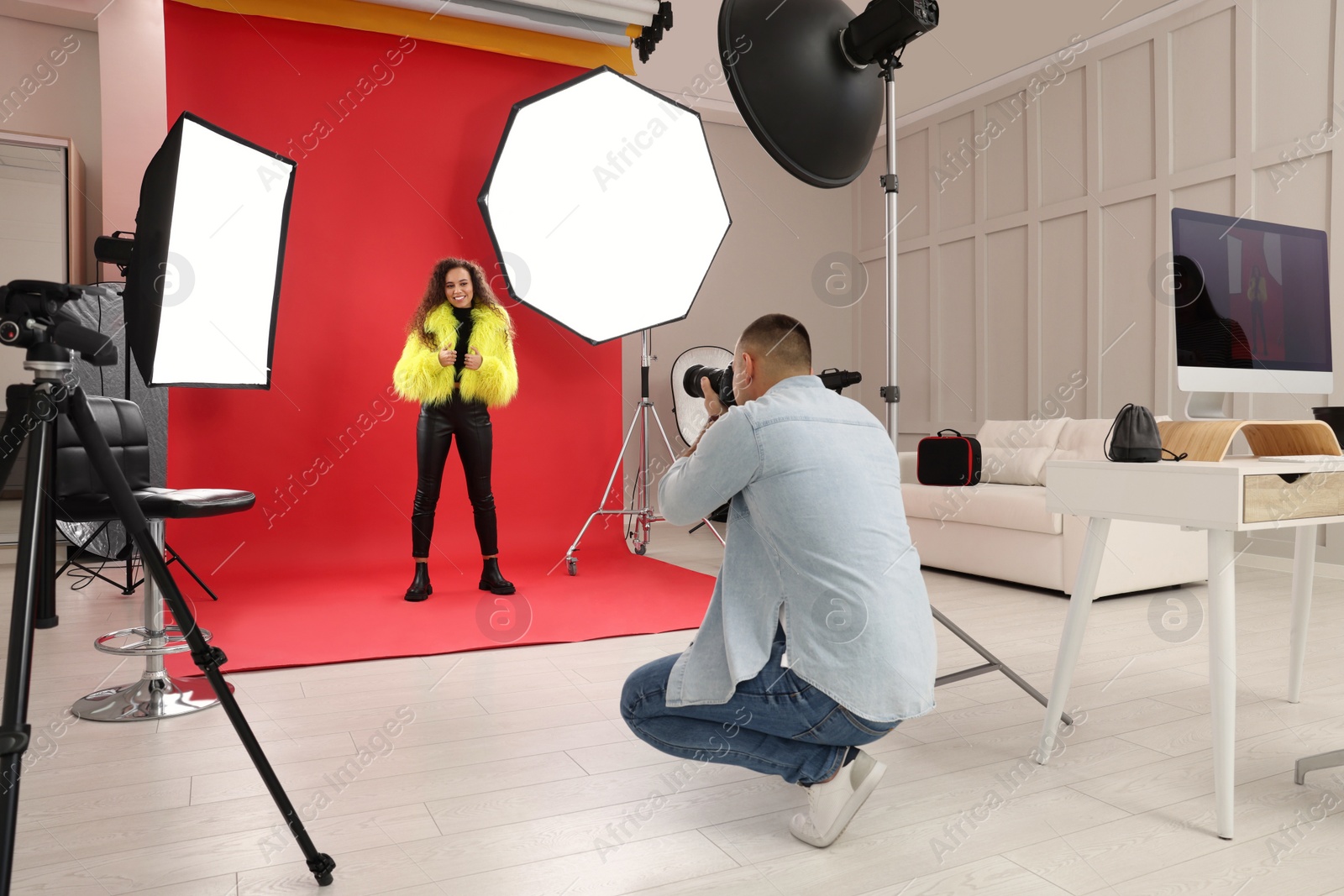 Photo of Beautiful African American model posing for professional photographer in studio