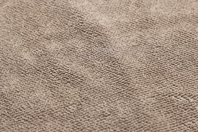 Dry soft brown towel as background, closeup