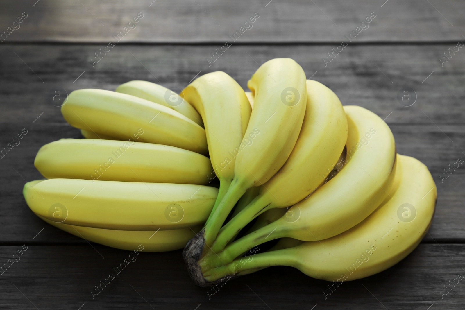 Photo of Ripe yellow bananas on wooden table, flat lay