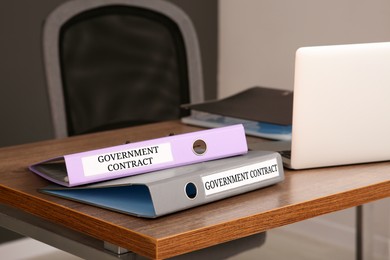 Image of Folders with Government Contract labels on desk in office