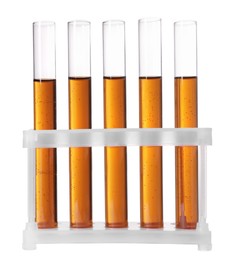 Photo of Test tubes with brown liquid in stand on white background