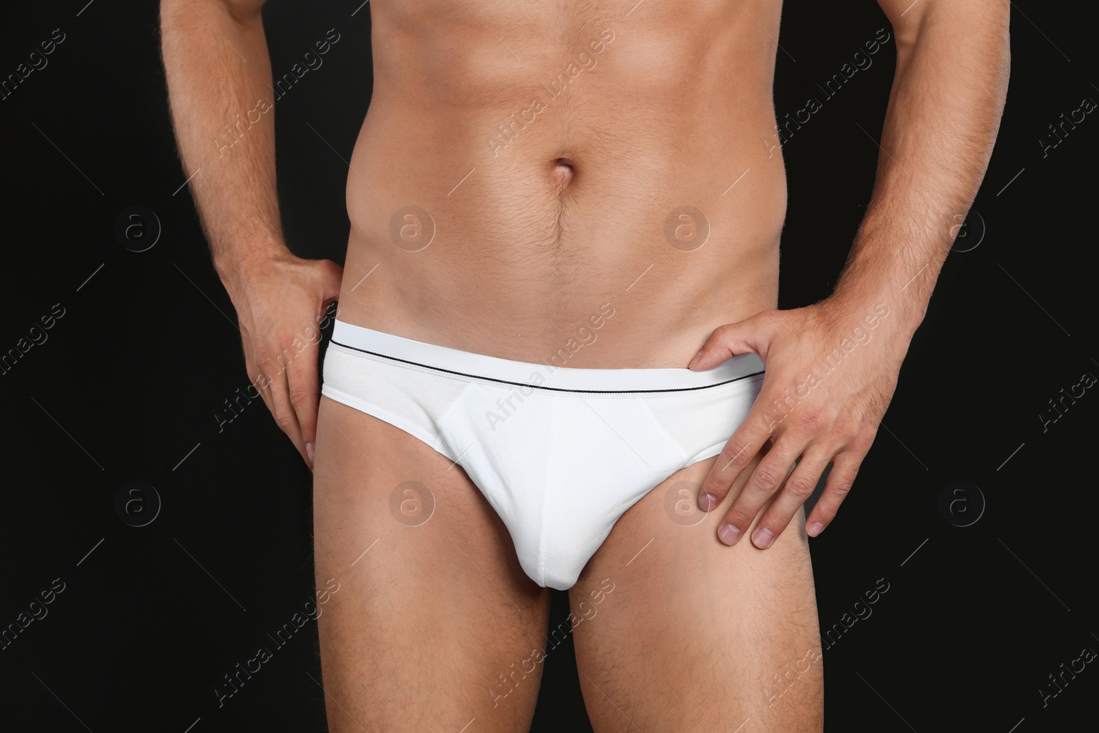 Photo of Man in underwear on black background, closeup