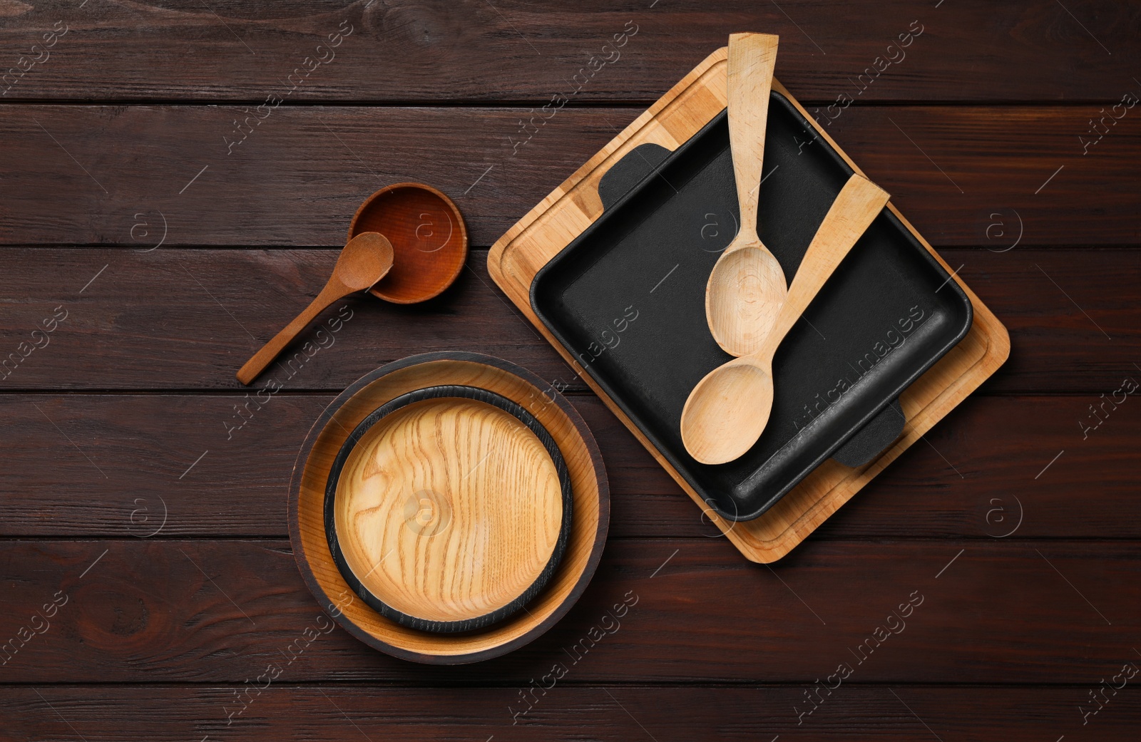 Photo of Set of modern cooking utensils on brown wooden table, flat lay