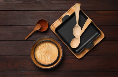 Set of modern cooking utensils on brown wooden table, flat lay