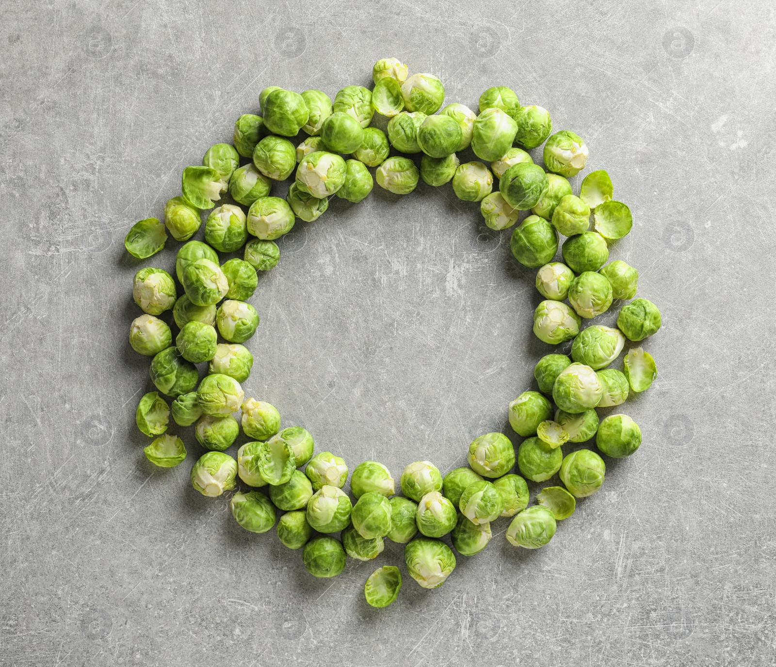 Photo of Frame made with Brussels sprouts on grey background, top view. Space for text