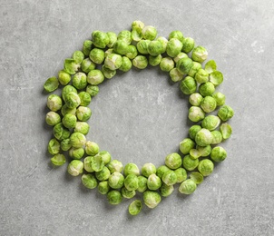 Frame made with Brussels sprouts on grey background, top view. Space for text