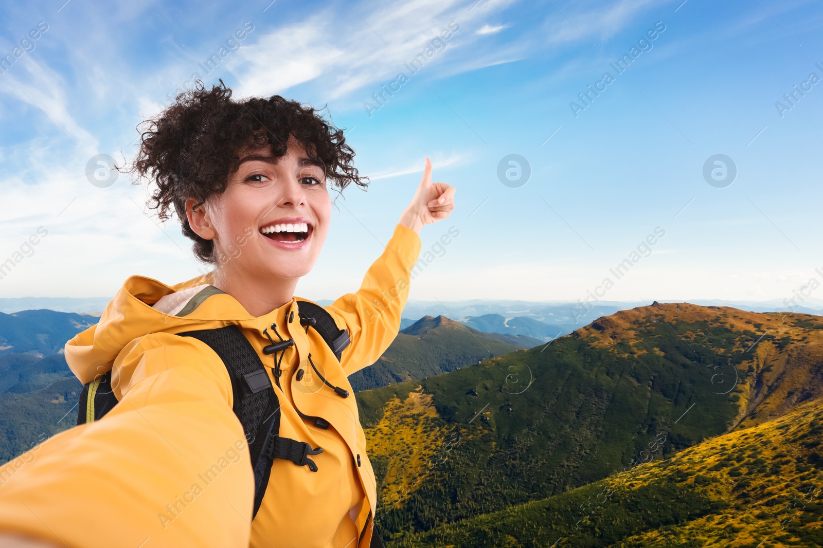 Image of Beautiful young woman taking selfie in mountains