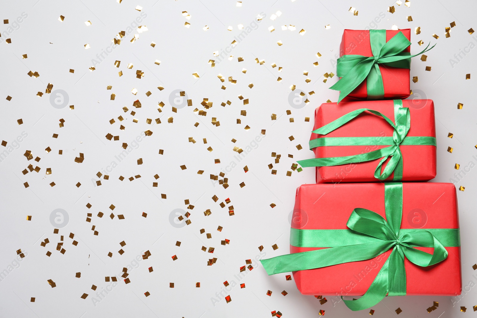 Photo of Christmas tree made with different gift boxes on white background, flat lay. Space for text