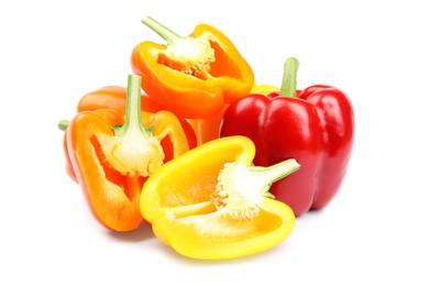 Whole and cut bell peppers on white background