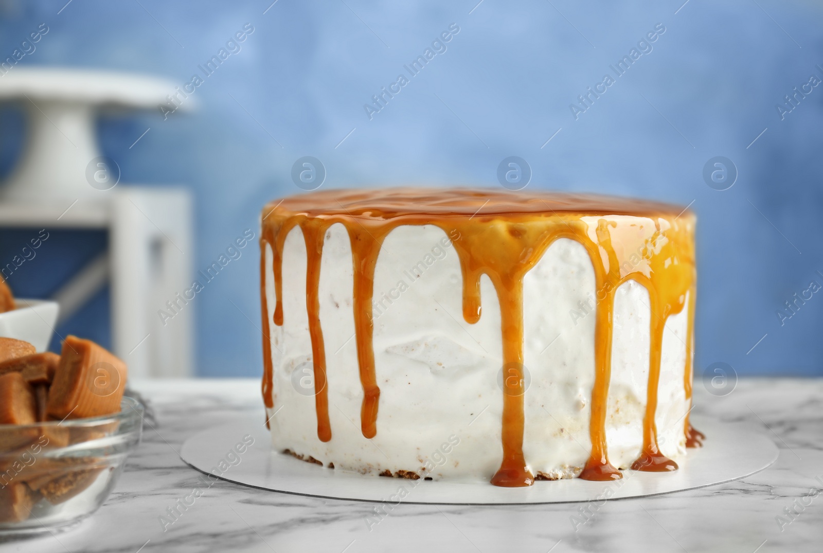 Photo of Delicious homemade cake with caramel sauce on table