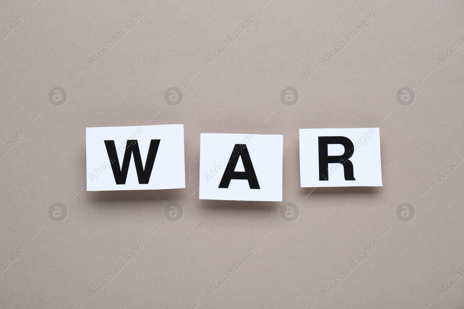 Photo of Word War made of cards with letters on grey background, top view