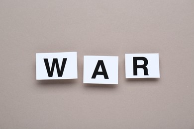 Word War made of cards with letters on grey background, top view