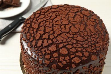 Delicious chocolate truffle cake on light table, closeup