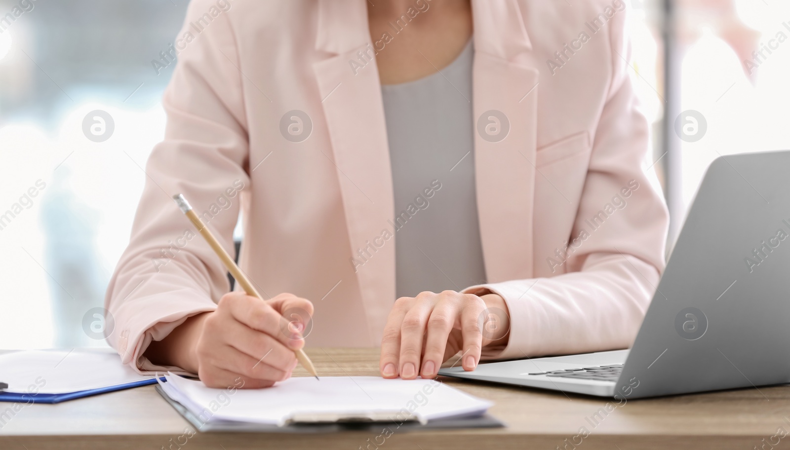 Photo of Consultant working at table in office, closeup