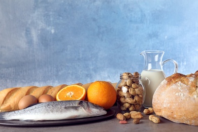Set of natural products on table against light blue background, space for text. Food allergy