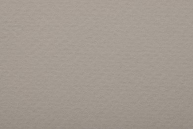 Texture of light grey paper sheet as background, top view