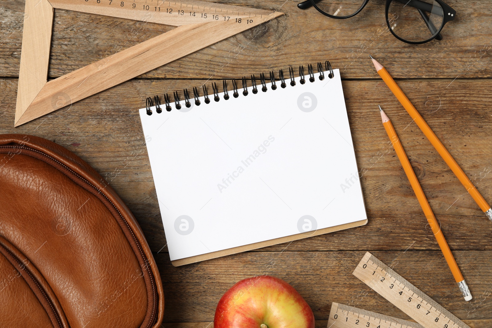 Photo of Flat lay composition with stationery on wooden table, space for text. Teacher's Day