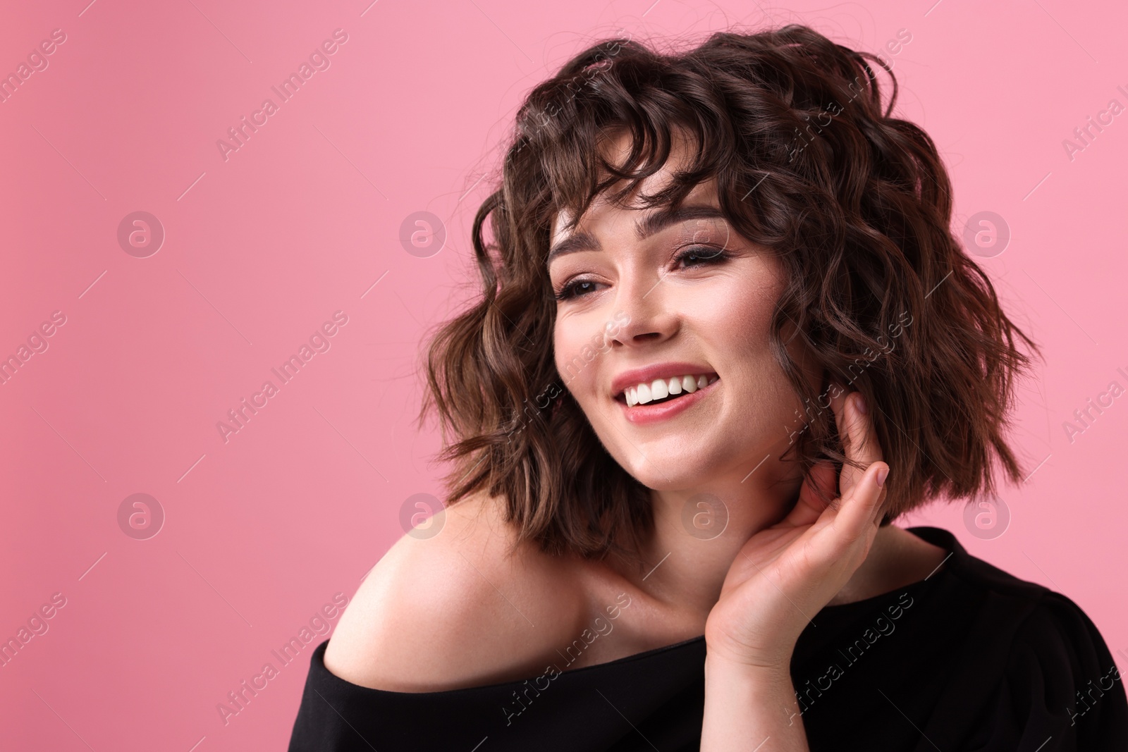 Photo of Portrait of beautiful young woman with wavy hairstyle on pink background. Space for text