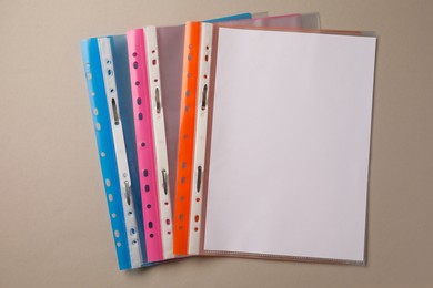 File folders with punched pockets on light grey background, flat lay