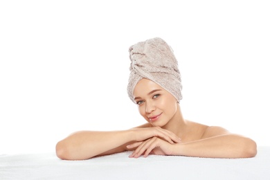 Portrait of young pretty woman with towel on white background