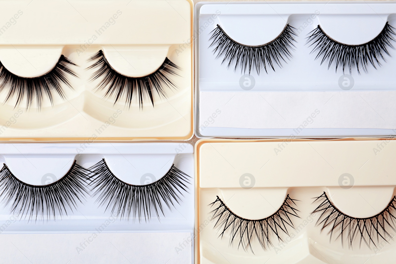 Photo of Different types of false eyelashes in packs, top view