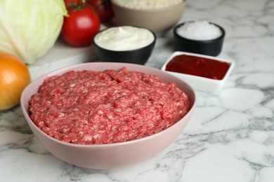 Set of ingredients for preparing stuffed cabbage rolls on white marble table