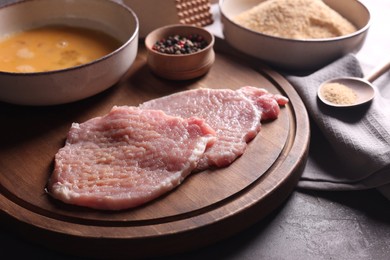 Photo of Cooking schnitzel. Raw pork slices and other ingredients on grey table, closeup