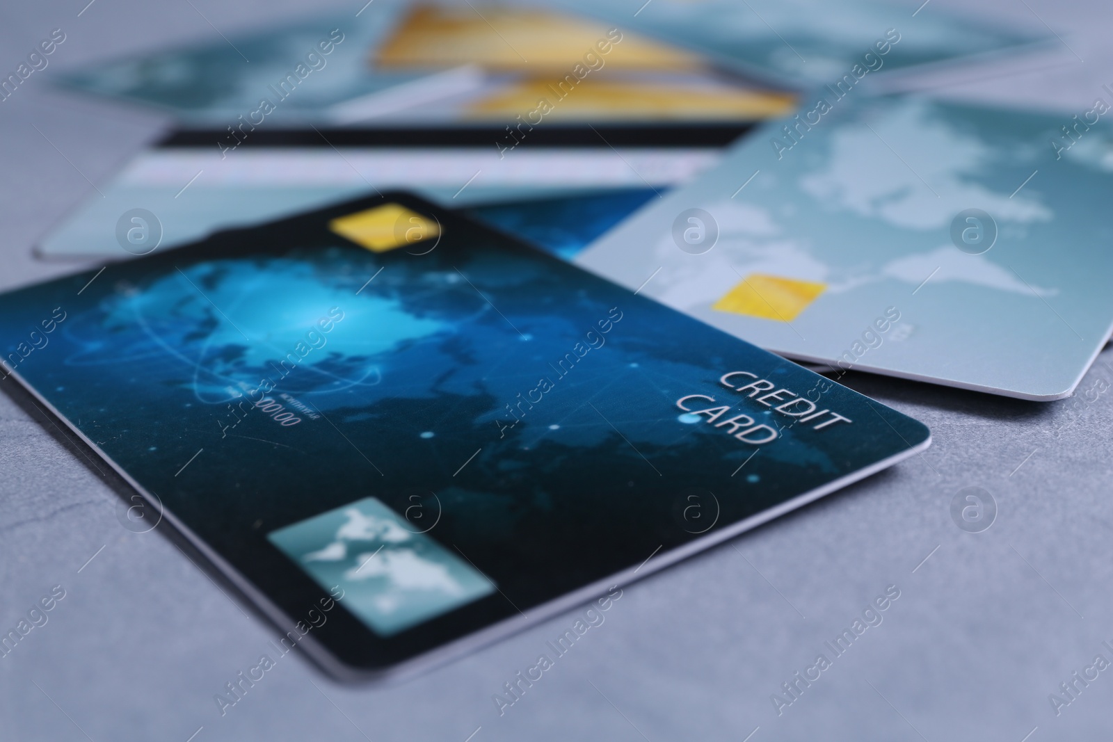 Photo of Credit cards on grey textured table, closeup