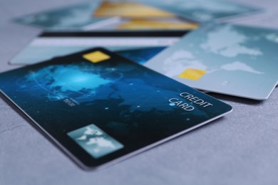 Photo of Credit cards on grey textured table, closeup