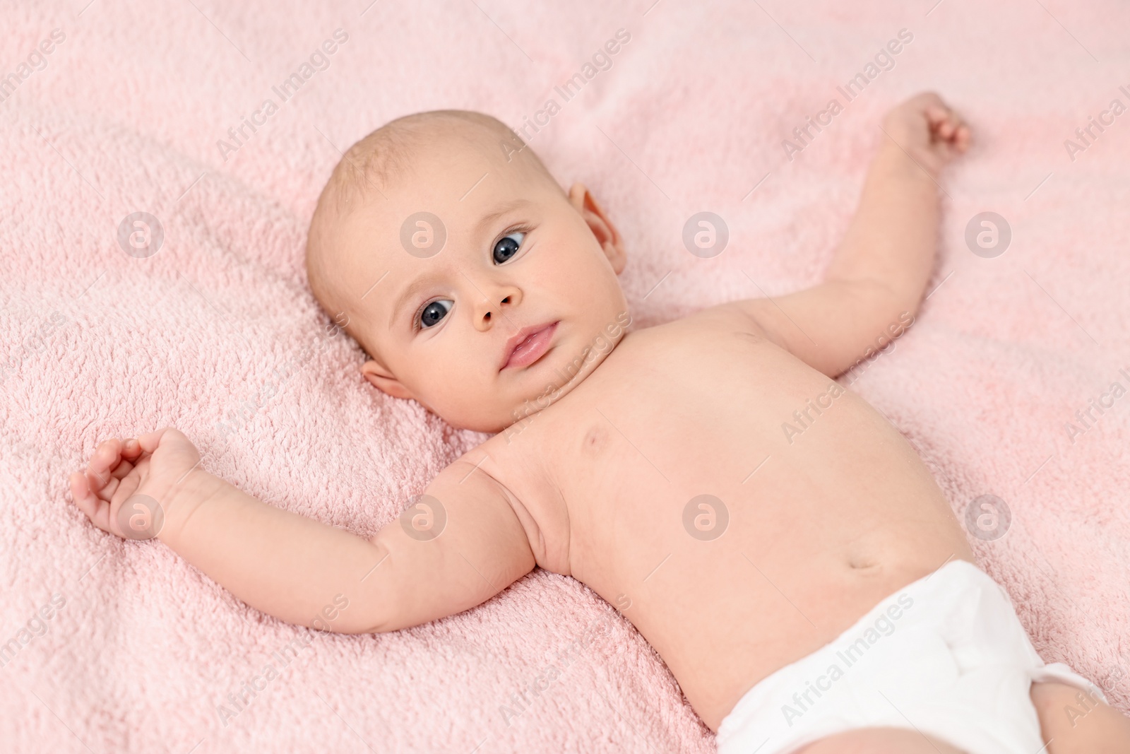 Photo of Cute little baby with cream on face on pink blanket, above view